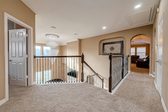 corridor featuring carpet floors and an inviting chandelier