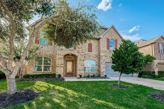 view of front of property featuring a garage and a front lawn