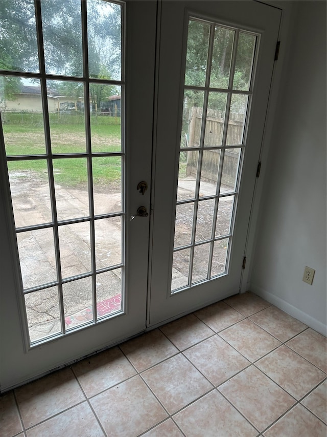 doorway with light tile patterned floors