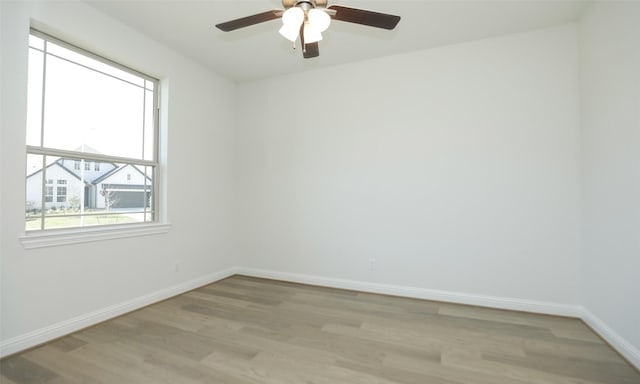 spare room featuring ceiling fan and light wood-type flooring