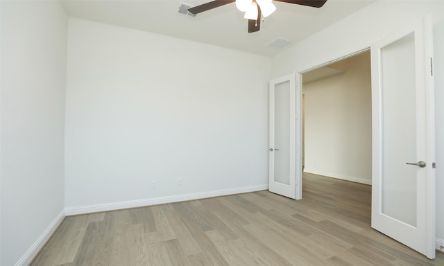 spare room featuring ceiling fan and light hardwood / wood-style floors