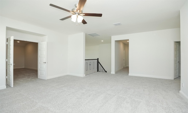 carpeted spare room with ceiling fan