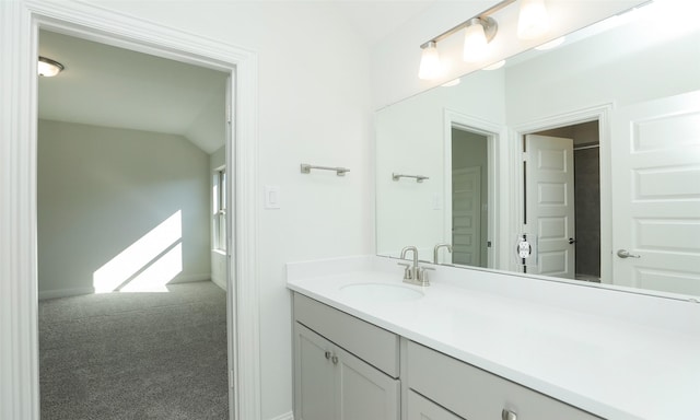 bathroom with vanity and vaulted ceiling