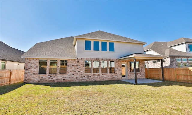 rear view of property with a lawn and a patio