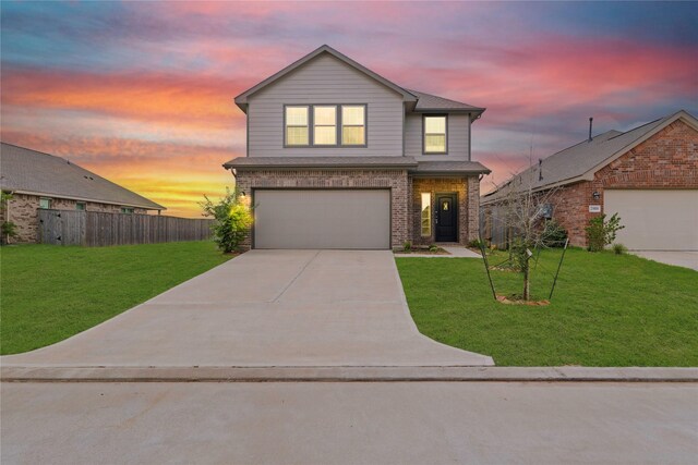 view of front property featuring a lawn and a garage