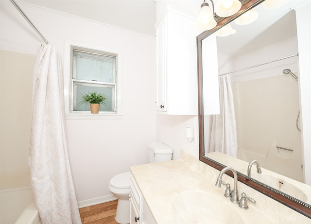 full bathroom featuring vanity, shower / bathtub combination with curtain, crown molding, hardwood / wood-style floors, and toilet