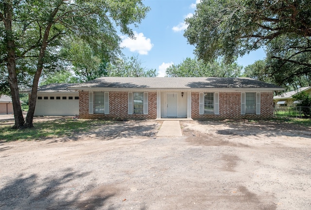 ranch-style home featuring a garage