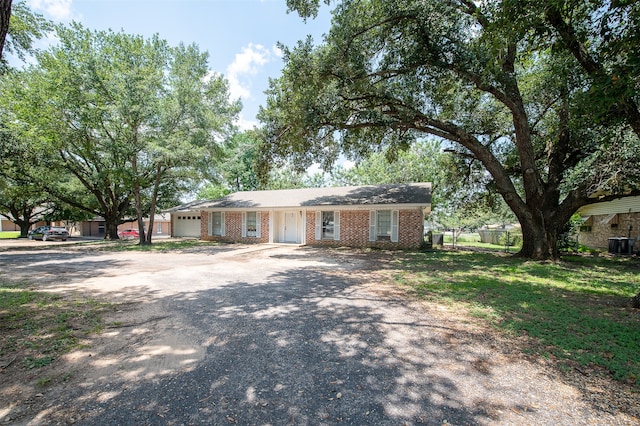 single story home with a garage and central AC