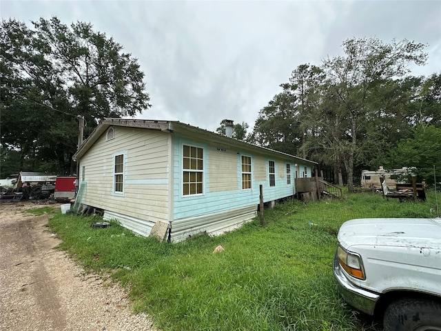 view of home's exterior with a lawn