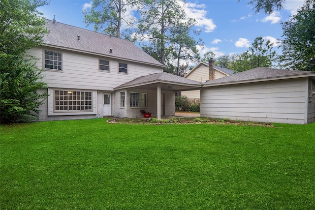 rear view of property with a yard