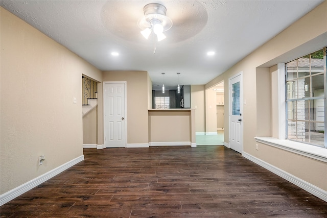 interior space featuring dark hardwood / wood-style floors and ceiling fan