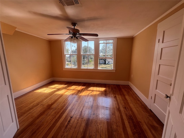 empty room with ceiling fan, wood-type flooring, and ornamental molding