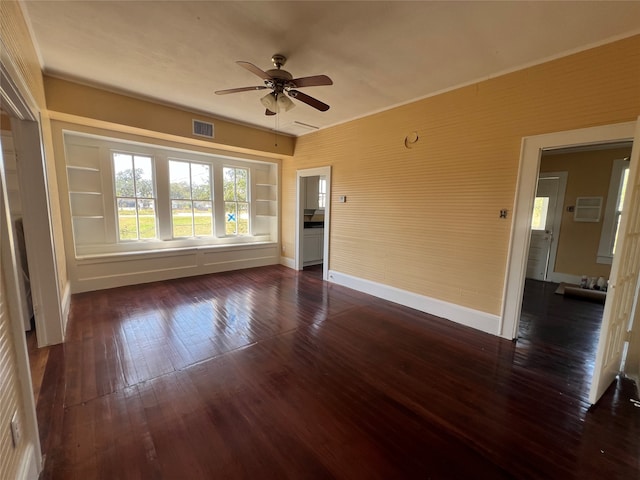 unfurnished room with ceiling fan and dark wood-type flooring