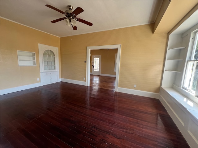 unfurnished room featuring ceiling fan, dark hardwood / wood-style flooring, and ornamental molding