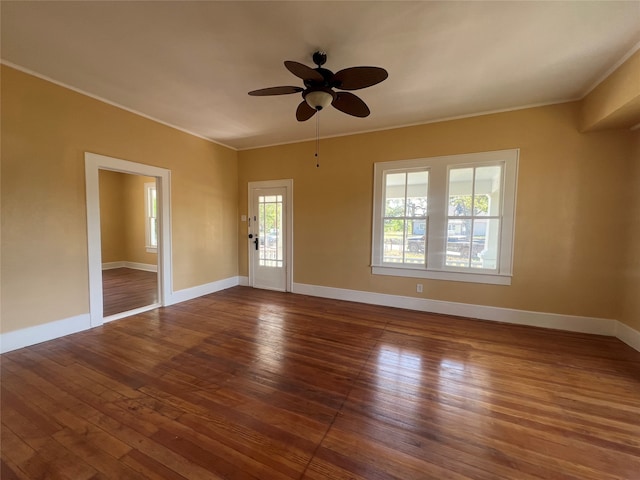 unfurnished room with dark hardwood / wood-style flooring, ceiling fan, and ornamental molding