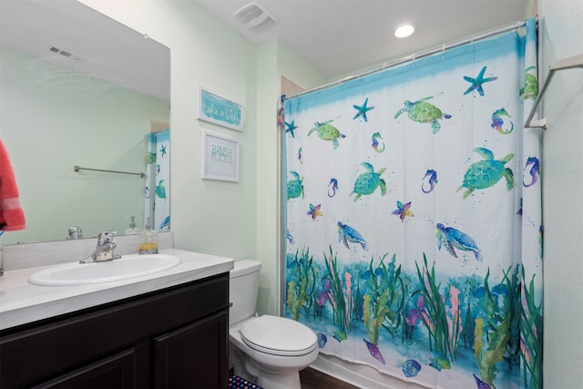 bathroom with toilet and vanity