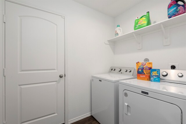 washroom with dark hardwood / wood-style floors and washer and dryer