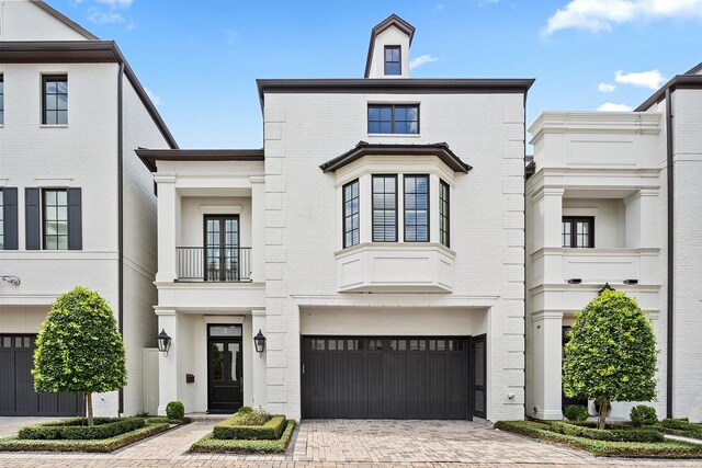 view of front of home featuring a balcony and a garage