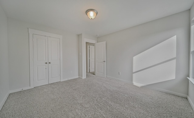 unfurnished bedroom featuring a closet and carpet floors