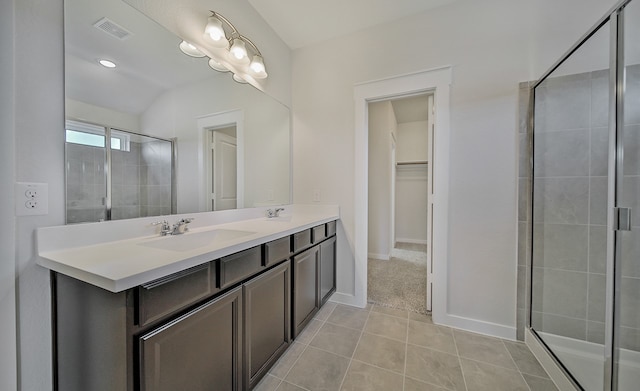 bathroom with an enclosed shower, tile patterned floors, and dual bowl vanity