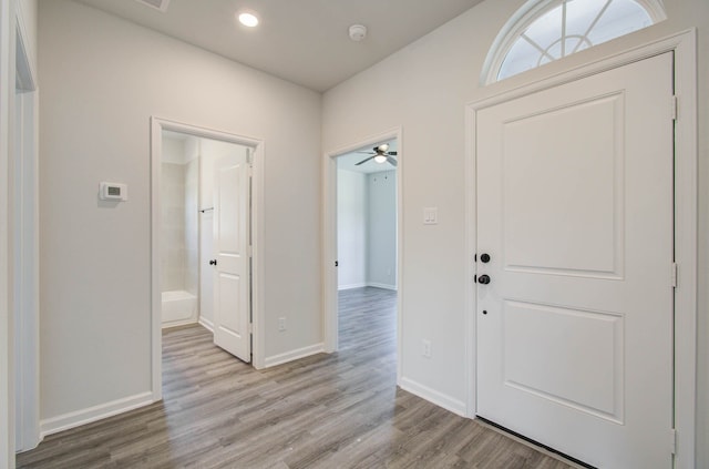 foyer featuring light wood-type flooring and ceiling fan