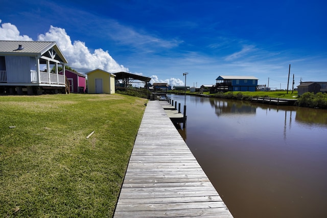 dock area with a yard and a water view