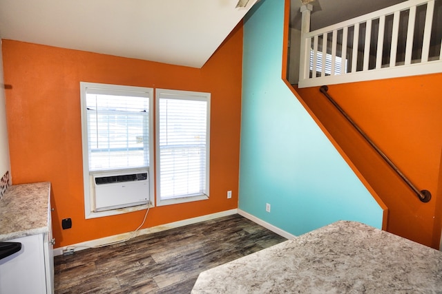 unfurnished bedroom featuring cooling unit and dark hardwood / wood-style flooring