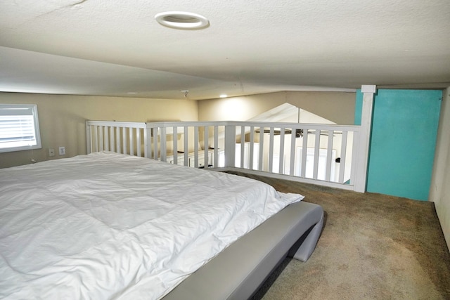 bedroom with carpet floors and a textured ceiling