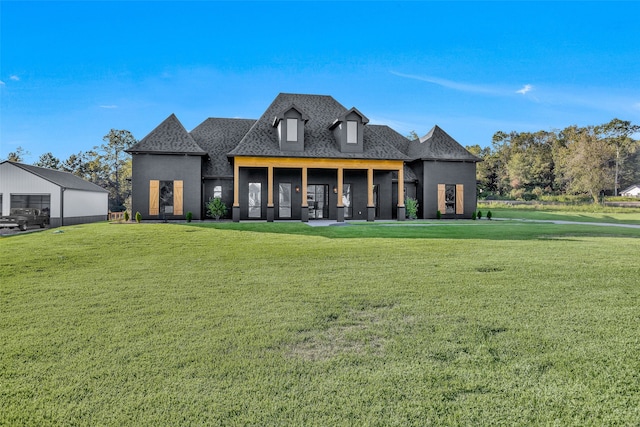 rear view of house featuring a lawn