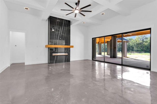 unfurnished living room featuring beam ceiling, a fireplace, and coffered ceiling