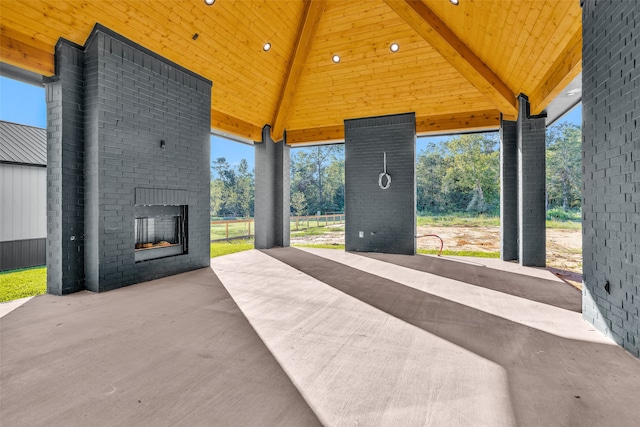 view of patio featuring a gazebo and an outdoor brick fireplace