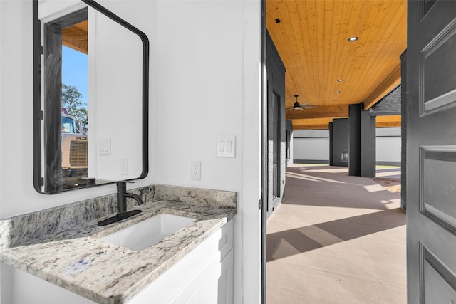 bathroom featuring ceiling fan, wooden ceiling, and vanity