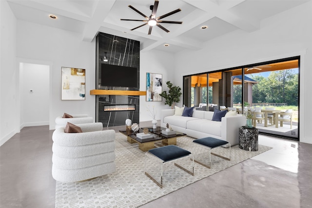 living room with beamed ceiling, concrete flooring, and coffered ceiling