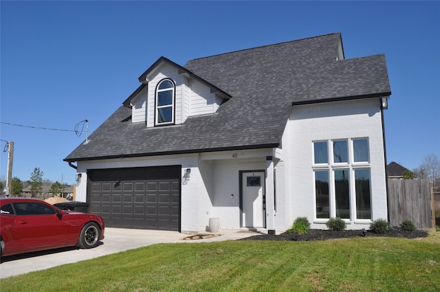 view of front of property featuring a garage and a front yard