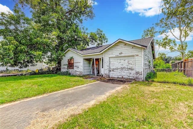 ranch-style home with a garage and a front lawn