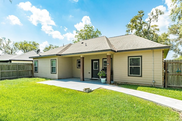 back of house with a yard and a patio area