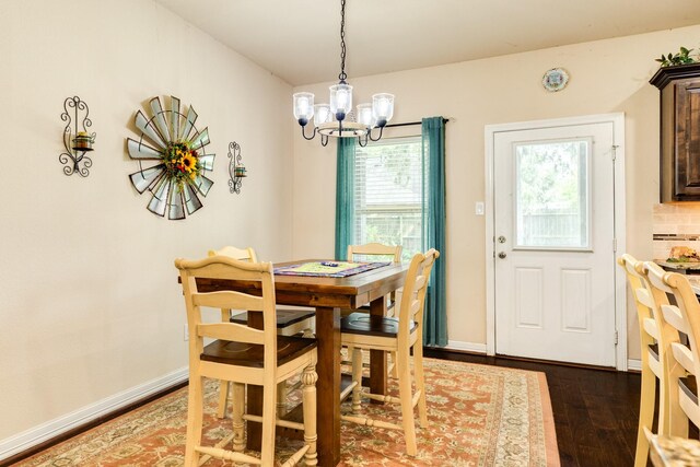 dining space featuring hardwood / wood-style flooring and a chandelier