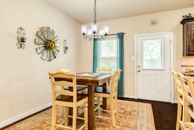 dining area featuring dark hardwood / wood-style floors and a notable chandelier