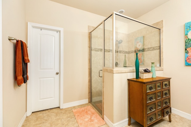 bathroom featuring vanity, tile patterned floors, and an enclosed shower