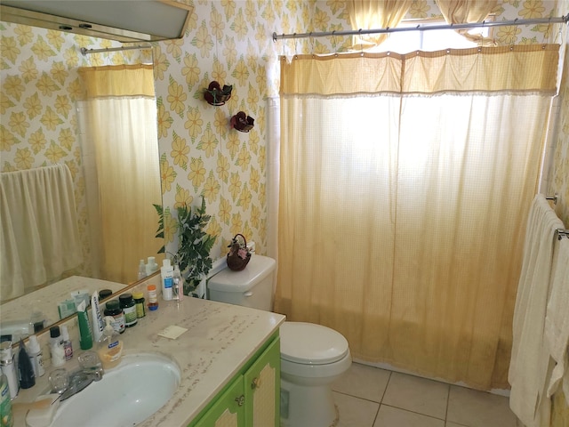 bathroom featuring tile patterned floors, vanity, and toilet