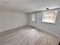 empty room with light hardwood / wood-style flooring