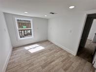 unfurnished room featuring light hardwood / wood-style floors