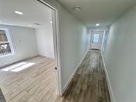 hallway with wood-type flooring