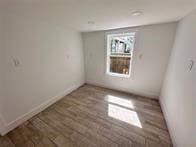 spare room with hardwood / wood-style floors