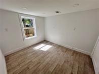 unfurnished room with dark wood-type flooring