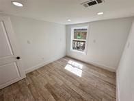 unfurnished room with dark wood-type flooring