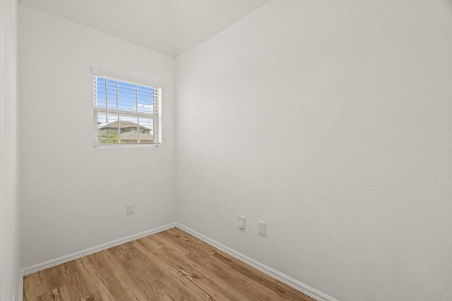 spare room with light wood-style flooring and baseboards