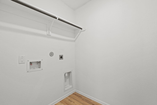 laundry area with laundry area, baseboards, hookup for a washing machine, hookup for an electric dryer, and light wood-style floors