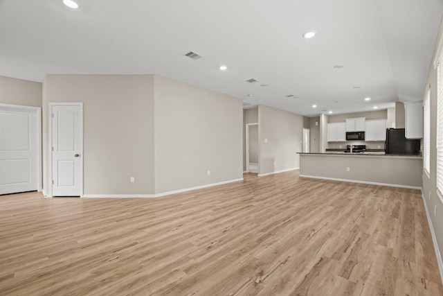 unfurnished living room featuring recessed lighting, visible vents, and light wood finished floors