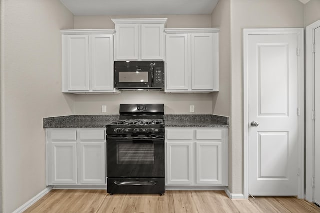 kitchen with black appliances, baseboards, white cabinets, and light wood-style floors